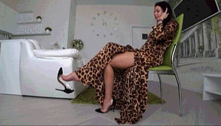 Toe topping and danglin in black shoes and a leopard print dress d