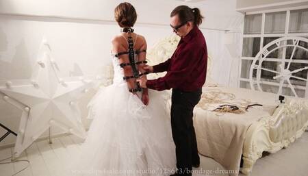 Bondage of Sofi with leather garters and bracers in a wedding dress_ V2