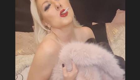 Smoker lady smokes her cork intensely with pleasure while playing with her fur jackets on her naked skin