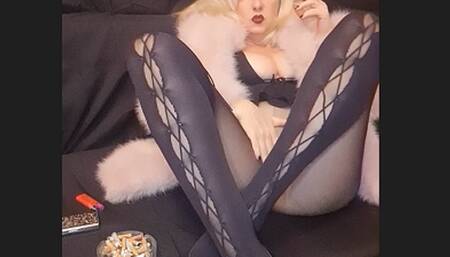 Smoker Mummy smoked a lot at the party today, but she still needs greedily a finish Marlboro chain smoke before the day ends