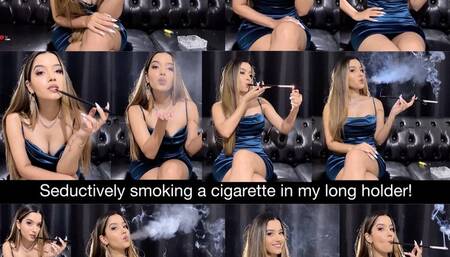 Seductively smoking a cigarette in my long holder wearing a sexy silk blue minidress and jewelry!