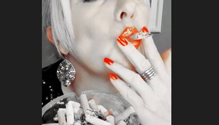 Smoker Mummy do chain smoke with deep powerful inhalations with lots of white smoke close up, in focus the red shiny lips and fingernails