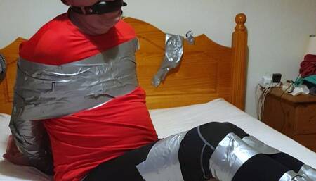 Man duct taped tight on bed in leggings 2-BBW domination,BBW Bondage,man in Bondage,male bondage,amateur,man tied up,bound and gagged man,tape bondage,duct tape,duct taped,taped up,leggings,feet,socks,struggling,CBT,gay bondage,