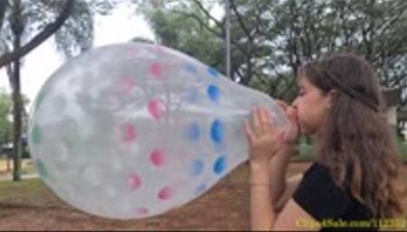 Katie Blows to Pop a Sprayed 18" Qualatex