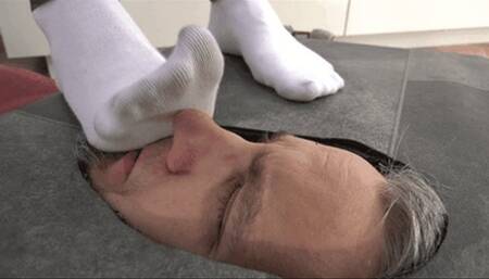 Slave's face under stinky socks and painful boots