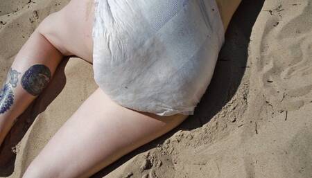 Nicole is sunbathing on the beach