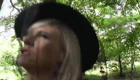 Busty MILF blows a man and rides his cock in the park