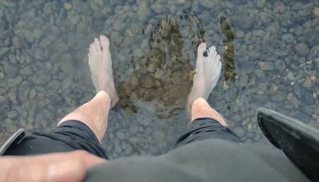 Tired and sweaty feet in the river waters