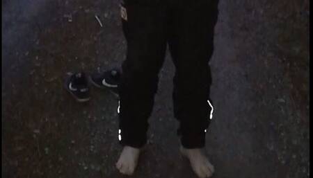 Bodycheck by Police on a forest path. Young man in Nikes and Sportwear in trouble