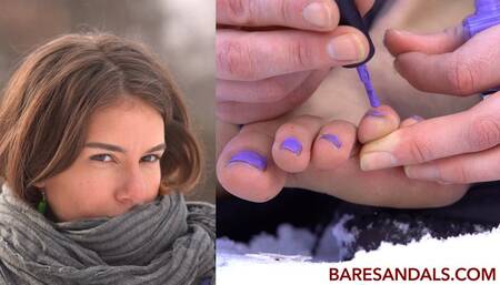 Teresa applies nail polish to her toes outside in the snow - 12400