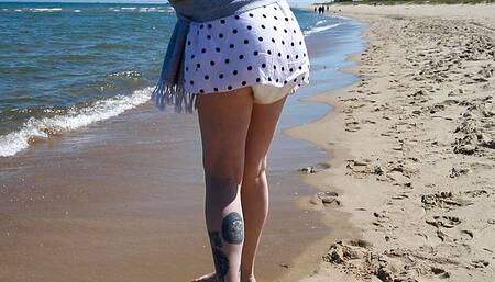Nicole walks along the seashore in a wet diaper