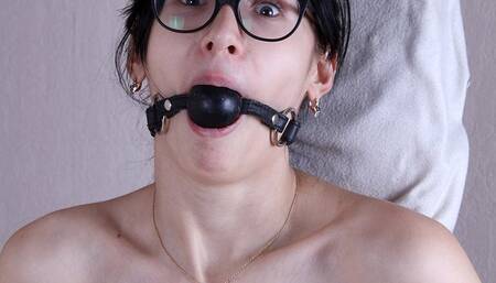 Ballgagged nude barefoot Alberta, wearing only eyeglasses, bound standing to the wooden post with crossbar, struggles and moans (HD WMV)