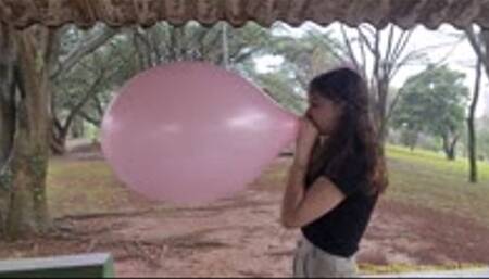 Katie Blows to Pop a Pink 16-Inch Chinese Balloon