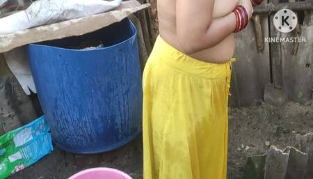 Indian woman bathing outside