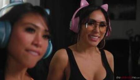 Ember Snow and Jena Larose on a black coloured leather sofa in a lesbian scene