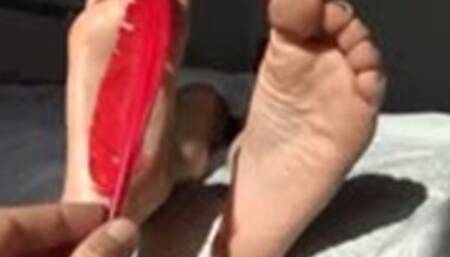 Feet tickling with a feather