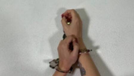 Althea handcuffed to the wall