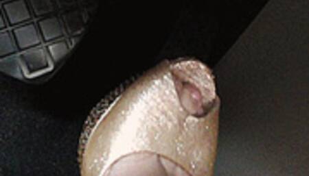 GOLDEN SHOES ARE PRESSING THE PEDAL OF A VOLKSWAGEN