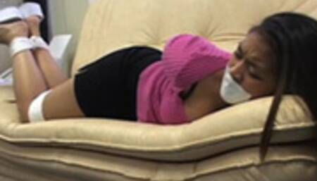 Pretty barefoot brunette Raven Knight rolls around tied and tape-gagged on a couch!