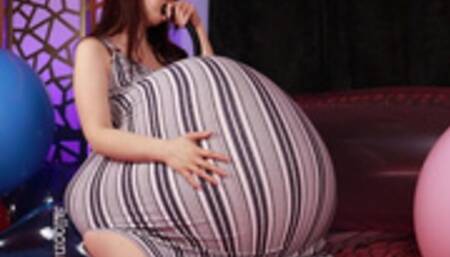 Weather Balloon Belly Inflating In Blue and White Striped Maternity Dress