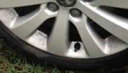 Red sole boots run over by my car in mud