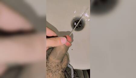 Young boy pissing in bathroom