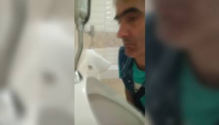 Hidden camera in the toilet filmed a fag licking urinal