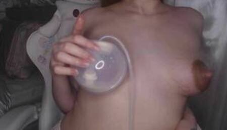 Redhead mommy extracts milk from her hard nipples