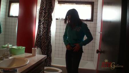 Cute and bespectacled Aubrey James walks about the set of her video shoot and pees on camera