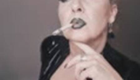 Close up at the exalted elegant smoke of a marlboro Red 100 in exotic makeup and black vinyl top