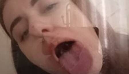 A passionate kiss with tongue through glass