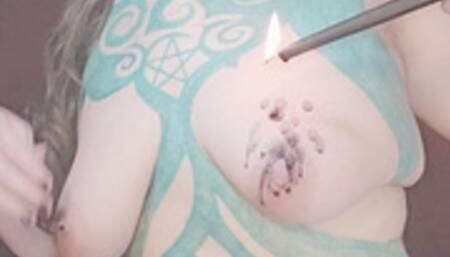 Goth girlfriend melts a black candle on her tit