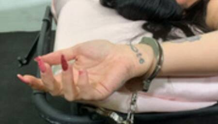 Althea struggling handcuffed on the bed