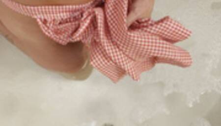 Carissa in the vintage apron and bra in the bath with bare feet