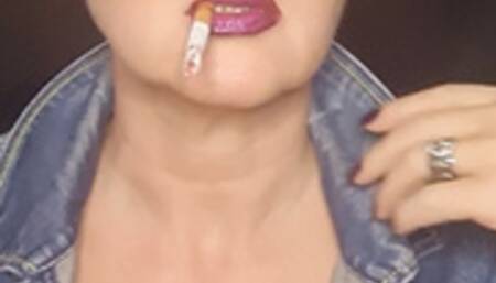 Smoker MILF in denim with big clevage smokes close up naughty seductive her Camel 100*sunglasses*glossy lips