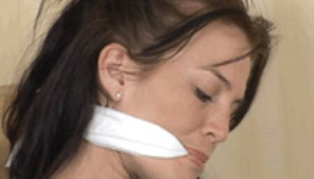 Bound, gagged and barefoot, hot brunette Shay Ruskin twists back and forth on a couch in her colorful harem costume!