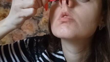 double penetration of nasal openings with tweezers