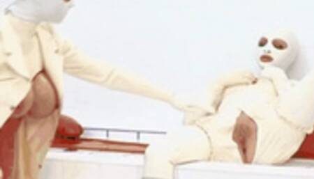 Two girls encased in white rubber catsuits - pussy fingered with latex gloves and warm piss emptied