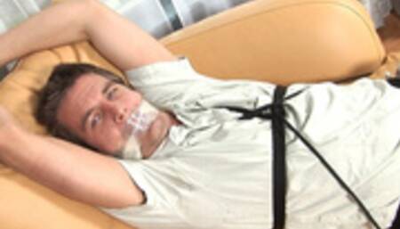 Triple gagged Travis proves no amount will keep him quiet!