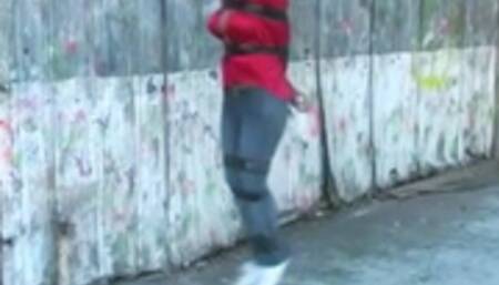 Gina Rae bound and gagged hopping through the old warehouse