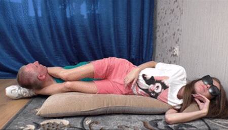 Teenage beauty lies on cushion keeping man's head between legs, vf2628x 1080p