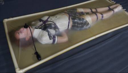Bondage schoolgirl in latex vacuum bed with vibrator and pear gag
