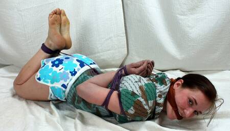 Ruby: cleave-gagged barefoot girl in top and shorts, hogtied with her hands in reverse prayer, gets her feet oiled and tickled (HD WMV)