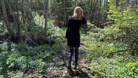 a beautiful girl is lost in the forest and is trying to get out on the road in high heeled boots, but there is a mountain of mud on her way, which she cannot climb in any way