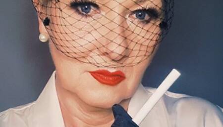 Elegant close up smoking a Marlboro Red 100 with hat and gloves