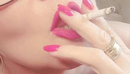 Sexy lascivious chain smoke with cough in black erotic lingerie, stocking, red lips and red nails