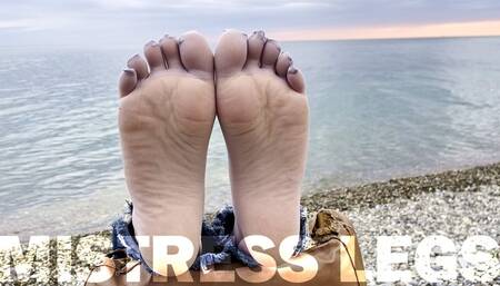 Sexy feet in gray nylon socks with separate toes teasing at the seashore (MOV HD)