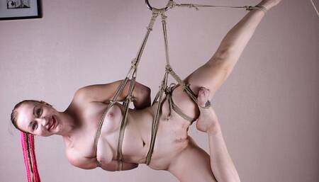 Amanda: nude barefoot girl, bound with hemp rope and suspended sideways, wiggles and turns around in the air (HD MOV)