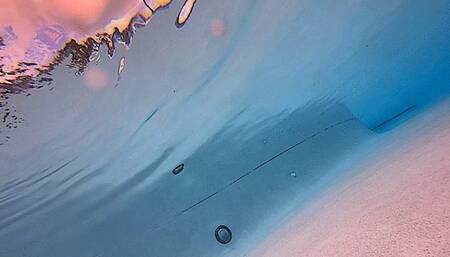 Carissa having a luau in a grass skirt and hibiscus bikini underwater in the public pool--breast exposure twice (oh my!)