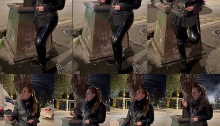 Lady Smoker smoking her Marlboro reds on the street at dawn - Crush -Nose exhales - Genuine leather jacket -PVC Vinyl pants - Boots